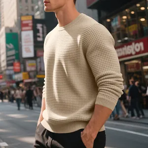 Close-up of beige waffle knit texture on men's crewneck sweatshirt in urban setting