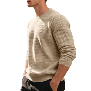 Close-up showing the intricate small checkered jacquard knit texture of the beige sweatshirt