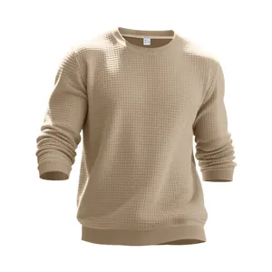 Close-up of beige men's long-sleeve sweatshirt showing the waffle knit small grid pattern.