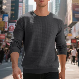 Close-up of grey waffle knit texture on a men's stylish long-sleeve crewneck sweatshirt
