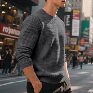 Detailed view of grey men's crewneck sweatshirt featuring a textured waffle grid pattern