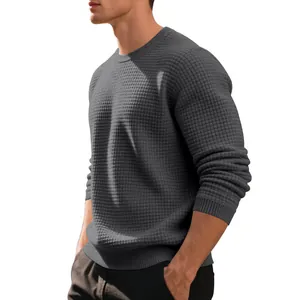 Side view of a men's grey waffle knit crewneck sweater with ribbed cuffs and hem.