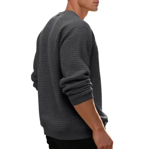 Close-up of men's dark gray long-sleeved sweatshirt with small square jacquard texture.