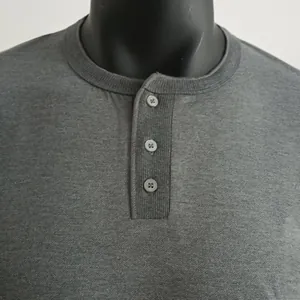 Close-up detail of grey men's Henley shirt neckline with three buttons
