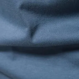 Close-up detail of soft blue cotton fabric texture for men's Henley shirt
