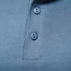 Detailed macro shot of blue men's Henley shirt showing buttons and jersey fabric texture