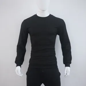 Close-up of men's black sweatshirt featuring a detailed checkered jacquard pattern.