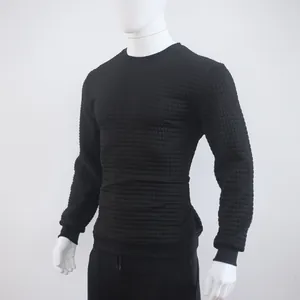 Detailed view showing the black jacquard checkered pattern on a men's crewneck sweatshirt