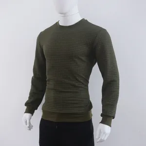 Detailed view of olive green waffle knit texture on a men's long sleeve crewneck top.