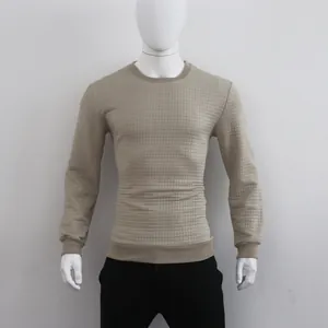 Detail view of men's khaki long-sleeve sweatshirt with waffle jacquard square texture