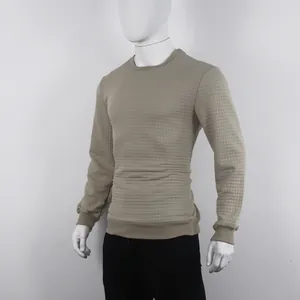 Macro view of khaki crewneck sweatshirt showing small jacquard square pattern texture