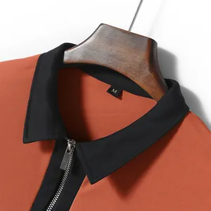 Close-up detail of a men's half-zipper polo shirt with a black contrast collar