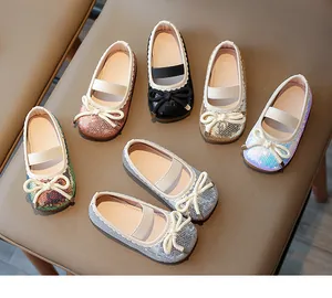 Various colors of sequin girls' princess shoes with bow detail on leather background