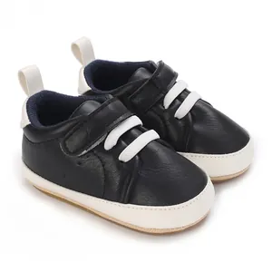 Detailed view of navy blue baby sneakers with white laces and soft anti-slip soles.