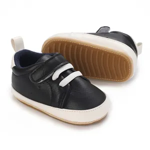 Detail view of black baby sneakers with non-slip rubber sole