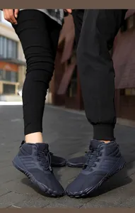Detailed view of mid-top fleece-lined winter snow boots worn in a street setting