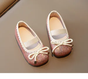 Detailed view of rose gold sequined Mary Jane shoes for girls with elegant white bow.