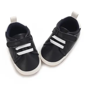 Detailed top view of navy blue baby boy casual sneakers featuring white soles and laces