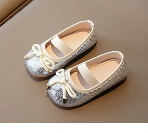 High-quality macro shot of silver sequined girls' princess shoes featuring a classic bow detail
