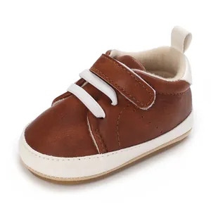 Close-up of brown infant casual sports shoe with white laces and soft white sole