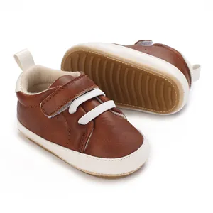 Detailed view of brown infant baby boy sneakers featuring soft leather and non-slip rubber soles