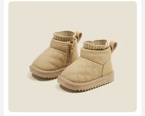 Detailed macro view of quilted beige toddler snow boots with warm knit collar