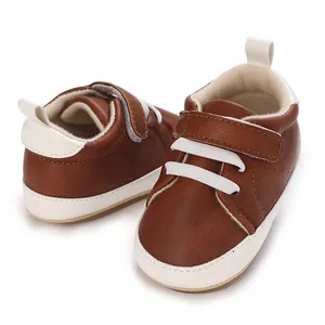 Detailed close-up of brown baby boy casual sneakers with white hook and loop strap.