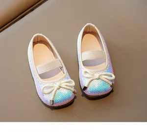Close-up detail of shimmering sequin children's shoes with elegant bow design