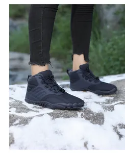 Outdoor dark blue warm hiking snow boots with faux fur lining shown on snowy ground