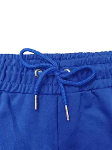 Close-up detail of a bright blue men's sports joggers waistband with drawstring and metal tips