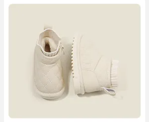 Detailed side view of off-white quilted baby snow boots with warm faux fur lining