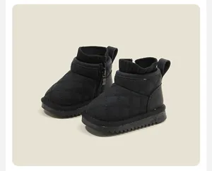 Detailed view of black quilted baby snow boots with knit collar and warm side zipper