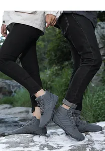 Outdoor macro view of couple wearing gray minimalist winter hiking boots with fur lining