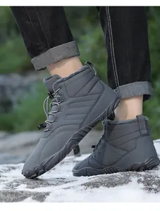 Close-up view of grey winter outdoor hiking snow boots with warm fleece lining being worn on snow