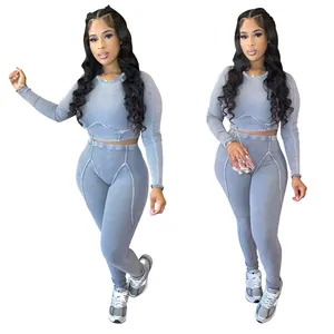 Detail view of grey ribbed two-piece workout set with long sleeve crop top and matching leggings