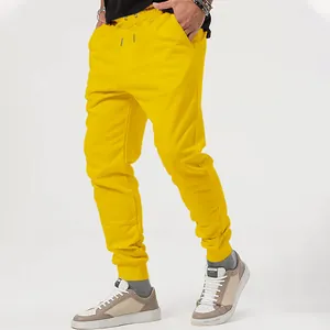 Detailed side view of vibrant yellow men's jogger pants featuring elastic cuffs and drawstring