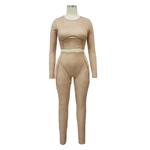 Detailed view of women's beige ribbed long-sleeve crop top and high-waist leggings