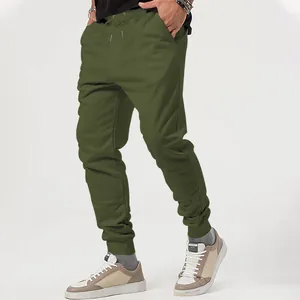 Close-up of olive green joggers showing tapered ankle cuffs and casual sneaker pairing