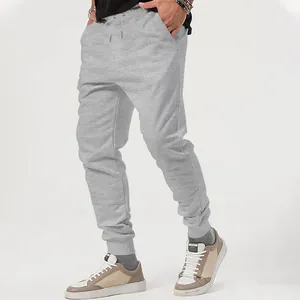 Detailed side view of grey men's joggers with drawstring waist and cuffed ankles