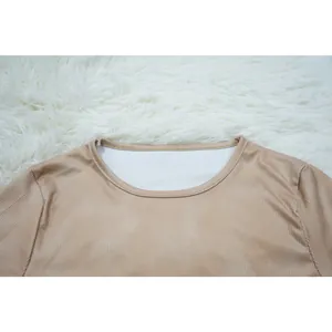 Close-up of a round neckline on a tan ribbed long sleeve women's athletic top.