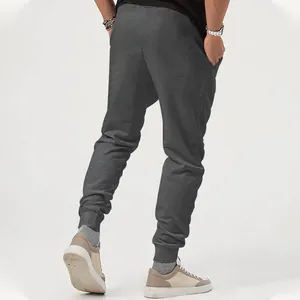 Rear view detail of men's dark grey athletic joggers with tapered ribbed ankle cuffs