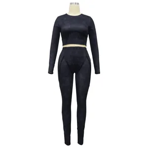 Women's black ribbed two-piece athletic set with long-sleeved crop top and leggings