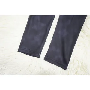 Detailed macro view of the ribbed fabric hem on dark marble activewear for women