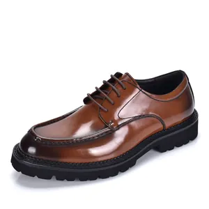 Close-up detail of brown patent leather men's dress shoe with a thick black lug sole