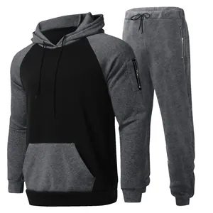 Men's two-piece fleece tracksuit set with color-block hoodie and matching joggers.