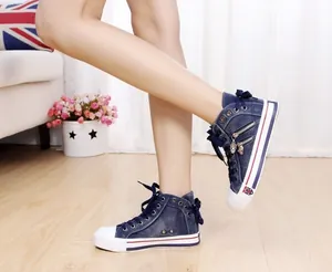 Women's blue denim high-top canvas sneakers featuring side zippers and bow details