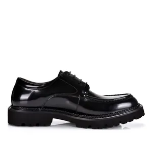Side view of shiny black patent leather men's business shoes with thick lug sole