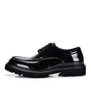 Side profile detail view of men's shiny black patent leather business formal dress shoes