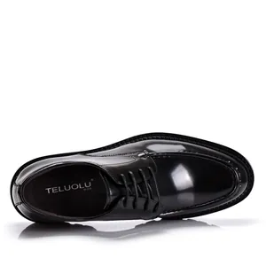 High-shine patent leather finish on men's black formal dress shoes, top-down detail view.