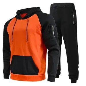 Men's two-piece orange and black contrast fleece hoodie and sweatpants tracksuit set